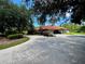 Single-story home with a large driveway and mature landscaping at 22105 Deer Pointe Xing, Bradenton, FL 34202