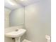 Small powder room with a pedestal sink and mirror at 4925 70Th E St, Palmetto, FL 34221