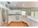 Kitchen features white cabinets, stainless steel appliances, and hardwood floors at 4925 70Th E St, Palmetto, FL 34221