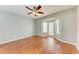 Bedroom with wood flooring, a ceiling fan, and access to a patio at 4925 70Th E St, Palmetto, FL 34221