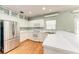 Modern kitchen with white cabinets, stainless steel appliances, and hardwood floors at 4925 70Th E St, Palmetto, FL 34221
