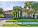 Mediterranean style home with lush landscaping and a two-car garage at 4625 Royal Dornoch Cir, Bradenton, FL 34211