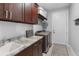 Bright laundry room with built-in cabinets, granite countertop, and sink at 8104 Bosco Rd, Port Charlotte, FL 33981