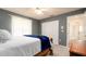 Bedroom with a wooden bed frame and blue blanket, and a view at 5897 Carriage Dr, Sarasota, FL 34243