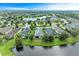 A beautiful aerial view of a house surrounded by a scenic landscape with a pond and neighborhood at 12198 Longview Lake Cir, Bradenton, FL 34211