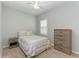Cozy bedroom with neutral color scheme, stylish furniture, and a bright window at 12198 Longview Lake Cir, Bradenton, FL 34211