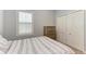 Bedroom with shuttered window with natural light, and spacious closet for storage at 12198 Longview Lake Cir, Bradenton, FL 34211