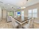 Open dining area and living room showcasing tray ceilings and lots of bright, natural light at 12198 Longview Lake Cir, Bradenton, FL 34211