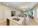 Kitchen with an island and dining area, seamlessly flowing into the living room and outdoor patio at 12198 Longview Lake Cir, Bradenton, FL 34211