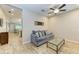 Comfortable living room featuring a gray couch, glass coffee table, and neutral tones at 12198 Longview Lake Cir, Bradenton, FL 34211