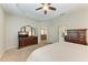 Spacious main bedroom with a ceiling fan, dresser, and access to an ensuite bathroom at 12198 Longview Lake Cir, Bradenton, FL 34211