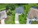 An aerial view of a home with a gray roof, green lawn and screened pool at 2204 Chipley Ave, North Port, FL 34286