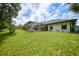 A large green backyard with a screened in pool and lots of space at 2204 Chipley Ave, North Port, FL 34286