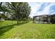 A large green backyard with a screened in pool at 2204 Chipley Ave, North Port, FL 34286