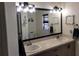 Bathroom with double sinks, large mirror, and decorative coastal themed artwork at 2204 Chipley Ave, North Port, FL 34286