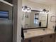 Bathroom with double sinks, large mirror, and shower at 2204 Chipley Ave, North Port, FL 34286