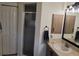 Bathroom featuring a glass-enclosed shower, wood cabinets, and neutral countertops at 2204 Chipley Ave, North Port, FL 34286