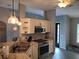 Well-equipped kitchen featuring stainless steel appliances, white cabinets, and durable countertops at 2204 Chipley Ave, North Port, FL 34286