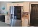 Bright kitchen featuring stainless steel refrigerator, white cabinets, and a sign that reads 'life is better in flip flops' at 2204 Chipley Ave, North Port, FL 34286