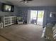 Cozy living room featuring plush carpeting, comfortable seating, and sliding glass doors leading to the outdoors at 2204 Chipley Ave, North Port, FL 34286