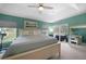 Bright main bedroom featuring tray ceilings, cool colors, and access to outdoor patio at 2204 Chipley Ave, North Port, FL 34286