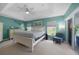 Serene main bedroom with tray ceilings, soft carpeting, and a sliding door to the backyard at 2204 Chipley Ave, North Port, FL 34286