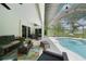 A covered patio featuring an outdoor ceiling fan, comfortable seating, and a pool at 2204 Chipley Ave, North Port, FL 34286