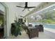 A covered patio featuring comfortable seating, lush plants, and a sparkling pool at 2204 Chipley Ave, North Port, FL 34286
