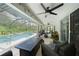 A covered patio featuring comfortable seating, an outdoor ceiling fan, and a pool at 2204 Chipley Ave, North Port, FL 34286