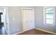 Light-filled bedroom with wood-look floors, a double door closet, and a large window at 5415 5Th N Ave, St Petersburg, FL 33710