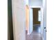Hallway with neutral walls, laminate flooring, and doorways leading to various rooms in the house at 5415 5Th N Ave, St Petersburg, FL 33710