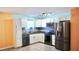 Modern kitchen with white cabinets, stainless steel appliances, and a stylish backsplash above the countertop at 5415 5Th N Ave, St Petersburg, FL 33710