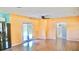 Open-concept living area with laminate flooring, a ceiling fan, and a doorway leading to the hallway and bathroom at 5415 5Th N Ave, St Petersburg, FL 33710