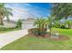 House exterior showing a two-car garage and manicured landscaping at 12198 Longview Lake Cir, Bradenton, FL 34211