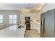 Modern kitchen with white cabinets, stainless steel appliances, and an island at 12198 Longview Lake Cir, Bradenton, FL 34211