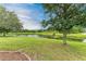 Landscaped backyard with pond and lush greenery at 12198 Longview Lake Cir, Bradenton, FL 34211