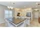 Bright dining area with wood table and white chairs, adjacent to kitchen at 12198 Longview Lake Cir, Bradenton, FL 34211