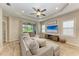 Spacious living room featuring a large TV, comfortable seating, and tile flooring at 12198 Longview Lake Cir, Bradenton, FL 34211