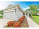 House exterior featuring a two-car garage and well-manicured landscaping at 12198 Longview Lake Cir, Bradenton, FL 34211