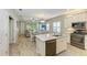 Open concept kitchen features island, stainless steel appliances, and white cabinetry at 12198 Longview Lake Cir, Bradenton, FL 34211