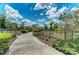Landscaped walkway with a bench and decorative fencing at 12198 Longview Lake Cir, Bradenton, FL 34211