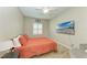 Bedroom with a large TV and coral bedding at 12198 Longview Lake Cir, Bradenton, FL 34211