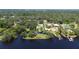 Wide aerial showcasing waterfront property with lush landscaping and homes at 11213 Riverview Dr, Riverview, FL 33578