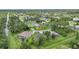 Aerial view of a residential neighborhood with houses and lush green landscaping at 2204 Chipley Ave, North Port, FL 34286