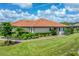 Single-story home with a terracotta tile roof, landscaped yard, and walkway at 15655 Sacile Ln, Lakewood Ranch, FL 34211