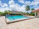 Inviting community pool with lounge chairs and patio area at 4068 Wilshire E Cir # 145, Sarasota, FL 34238