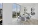 Modern dining area with city views and a unique mirror arrangement at 301 Quay Commons # 1406, Sarasota, FL 34236