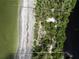 Aerial view of waterfront property with beach access and lush landscaping at 8440 Sanderling Rd, Sarasota, FL 34242