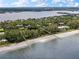 Aerial view of waterfront home and private beach at 8440 Sanderling Rd, Sarasota, FL 34242