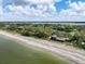 Aerial view of waterfront home with private beach access at 8440 Sanderling Rd, Sarasota, FL 34242